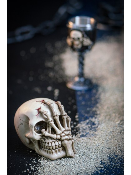 RESIN SKULL WITH HAND 16CM X 10CM X 12CM